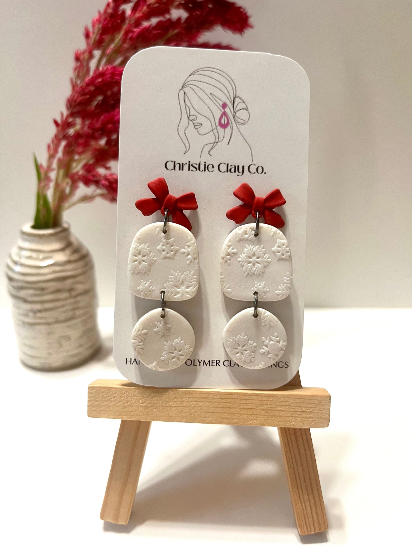 Christmas-Snowflake imprint dangles with red bow detail