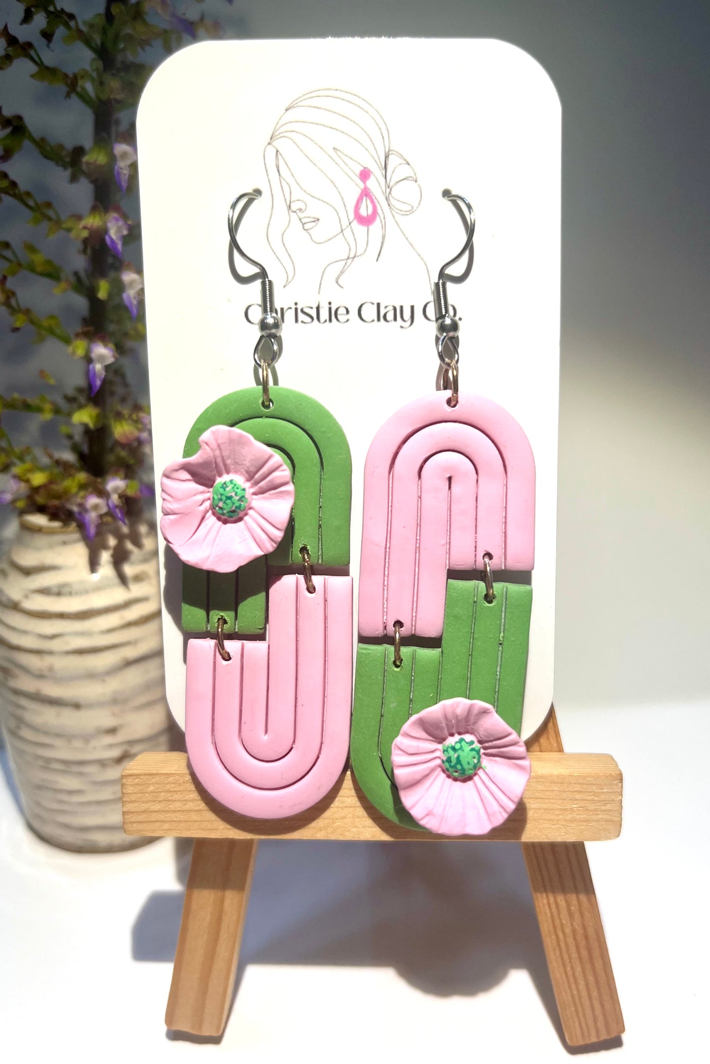 Green and pink symmetrical arch with flowers