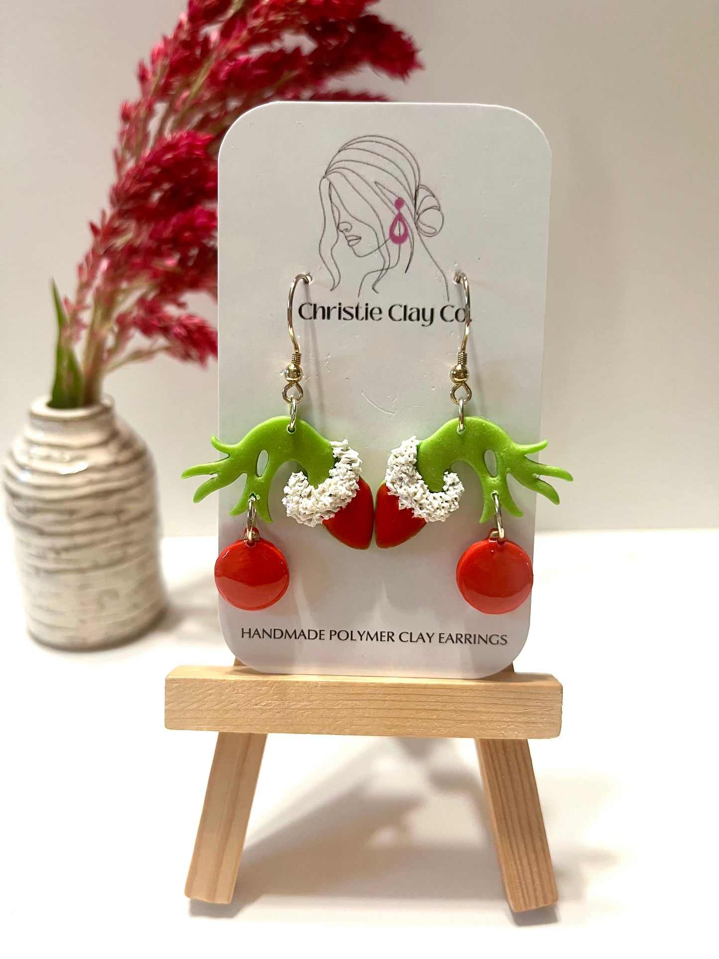 Christmas-Green meanie holding ornament